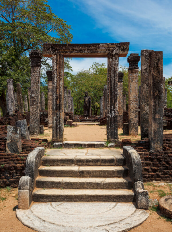 Stainding Buddha statue in ancient ruins. So-called Quadrangle in ancient city Polonnaruwa- famous tourist destination and archaelogical site, Sri Lanka